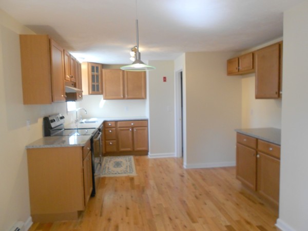 90-90B Waterhouse Road Bourne, MA 02532 - Photo 3 of 19 a kitchen with a sink a stove cabinets and wooden floor