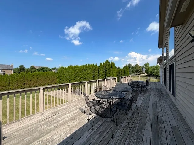 a view of balcony with seating space and wooden floor