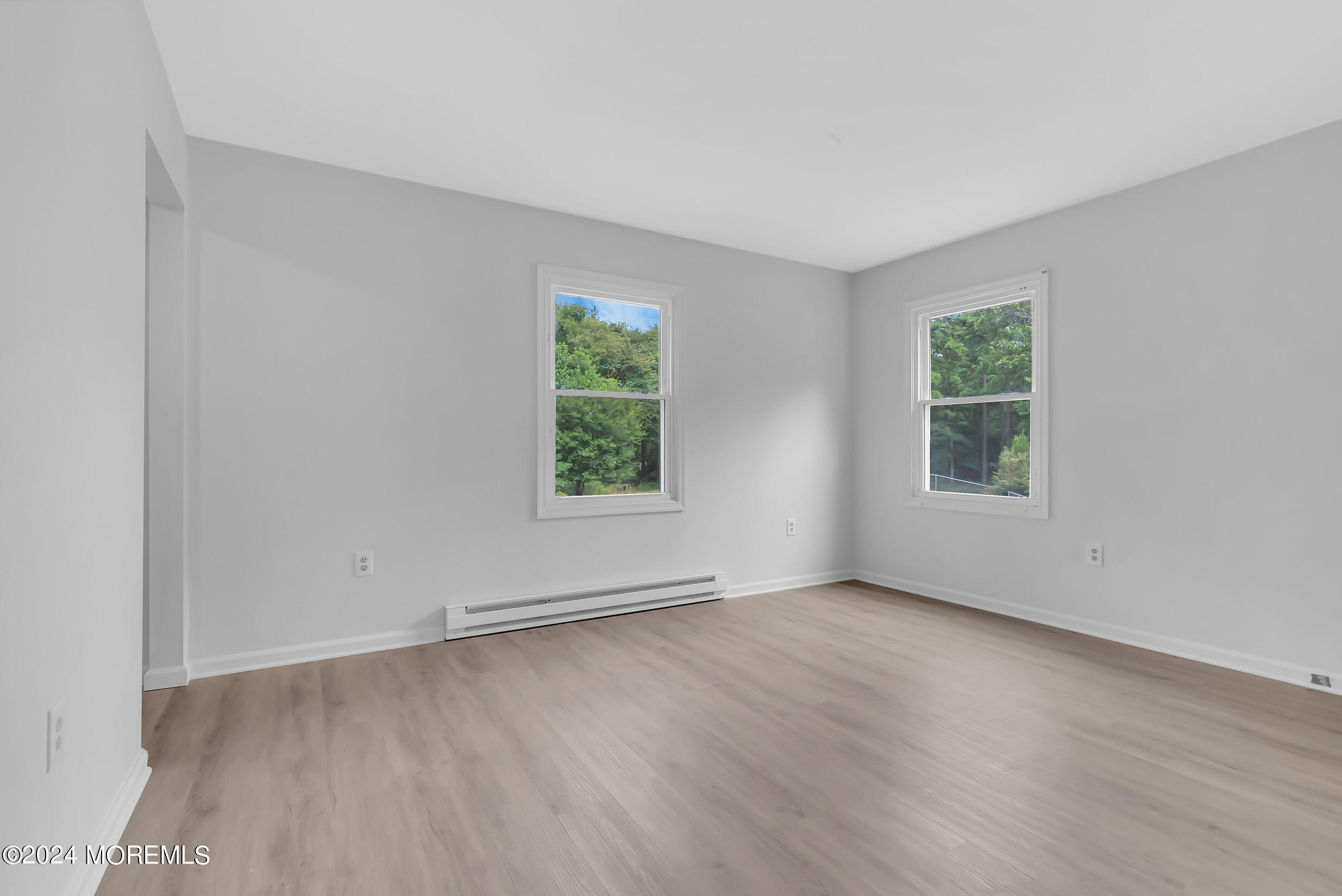 888 Anderson Road Jackson, NJ 08527 - Photo 45 of 81 an empty room with wooden floor and windows