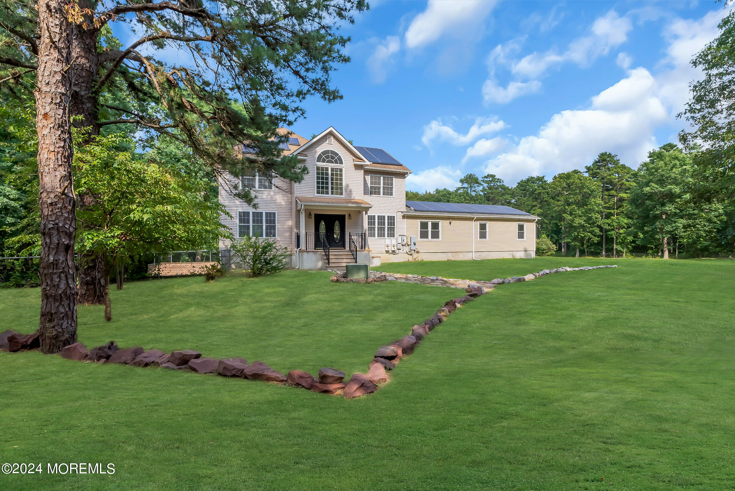 888 Anderson Road Jackson, NJ 08527 - Photo 6 of 81 a front view of a house with a garden