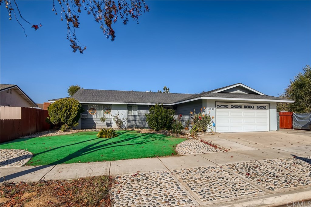 4038 Pala Road Oceanside, CA 92057 - Photo 1 of 1 a front view of a house with a yard and garage