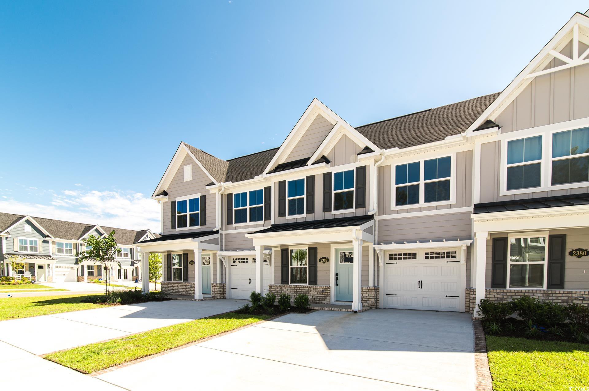 Craftsman-style house with driveway, a residential view, and an attached garage