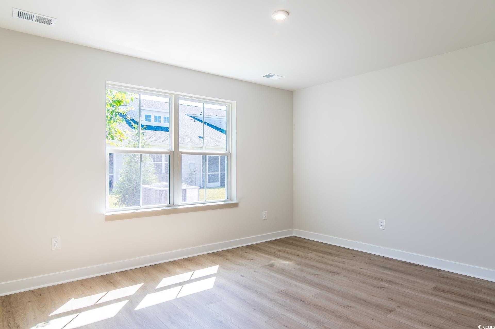 2382 Elowen Lane Longs, SC 29568 - Photo 12 of 36 Empty room with baseboards and light wood finished floors