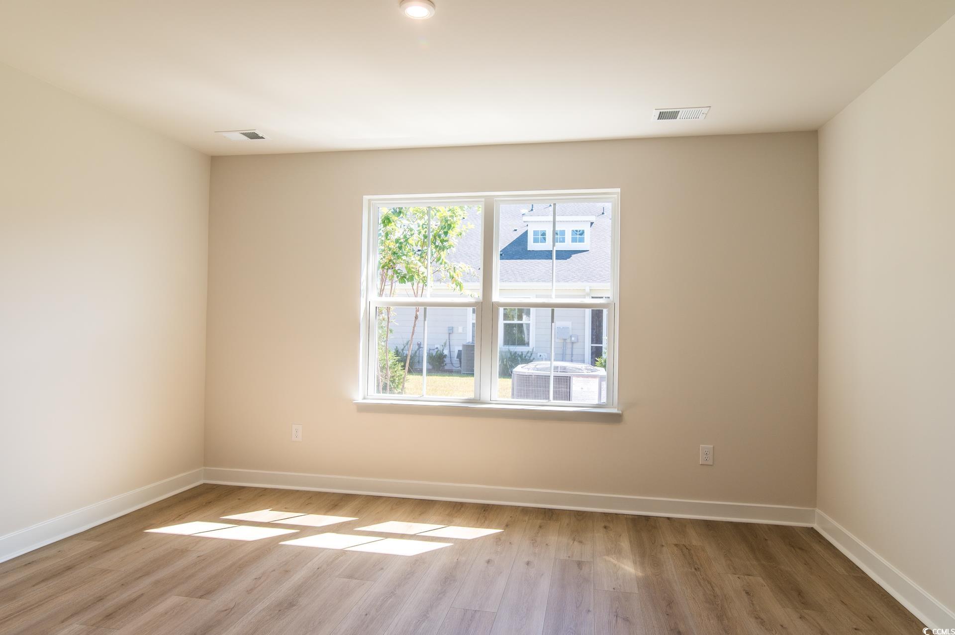 2382 Elowen Lane Longs, SC 29568 - Photo 13 of 36 Empty room featuring baseboards and light wood-type flooring