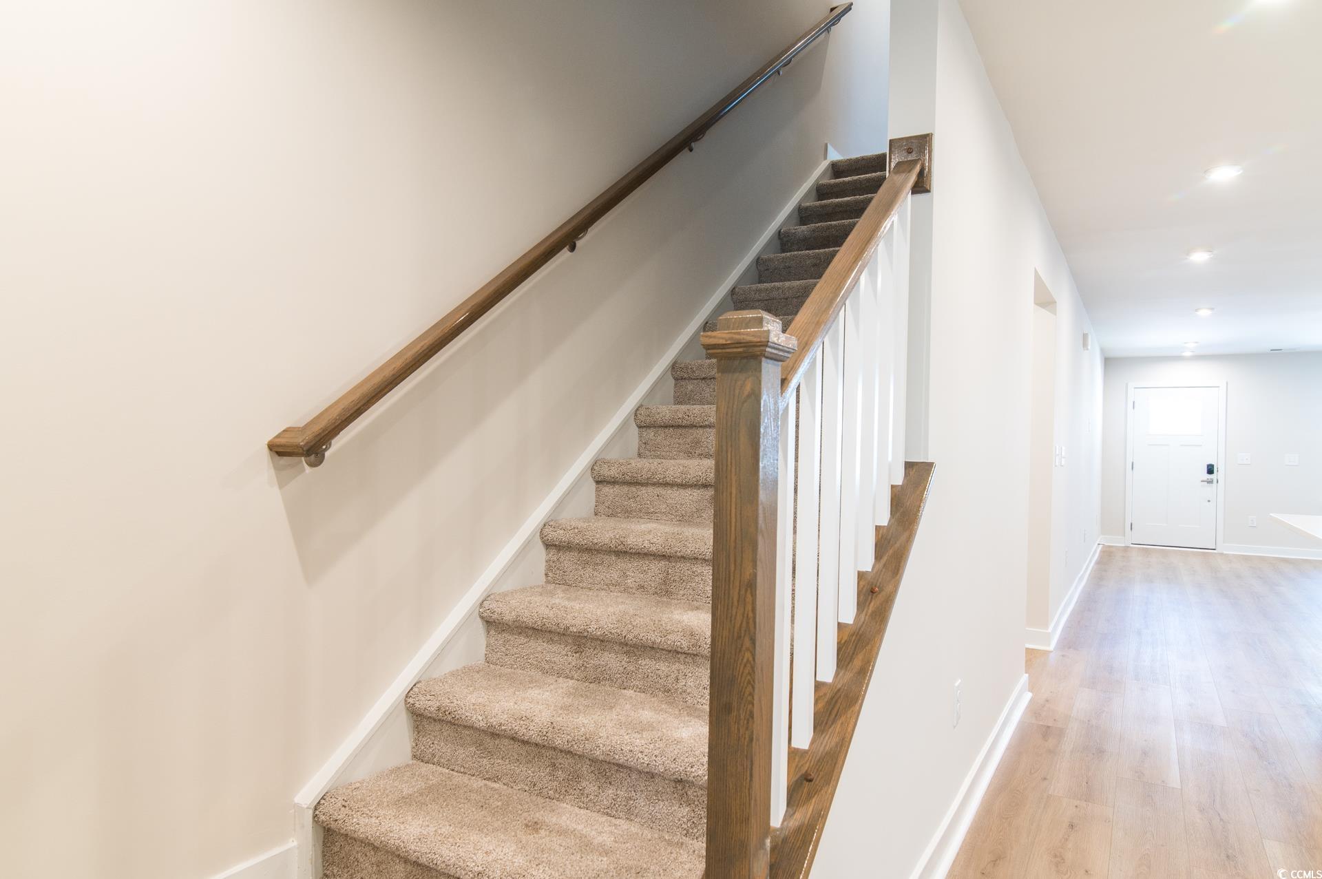 2382 Elowen Lane Longs, SC 29568 - Photo 17 of 36 Stairs with recessed lighting and wood finished floors