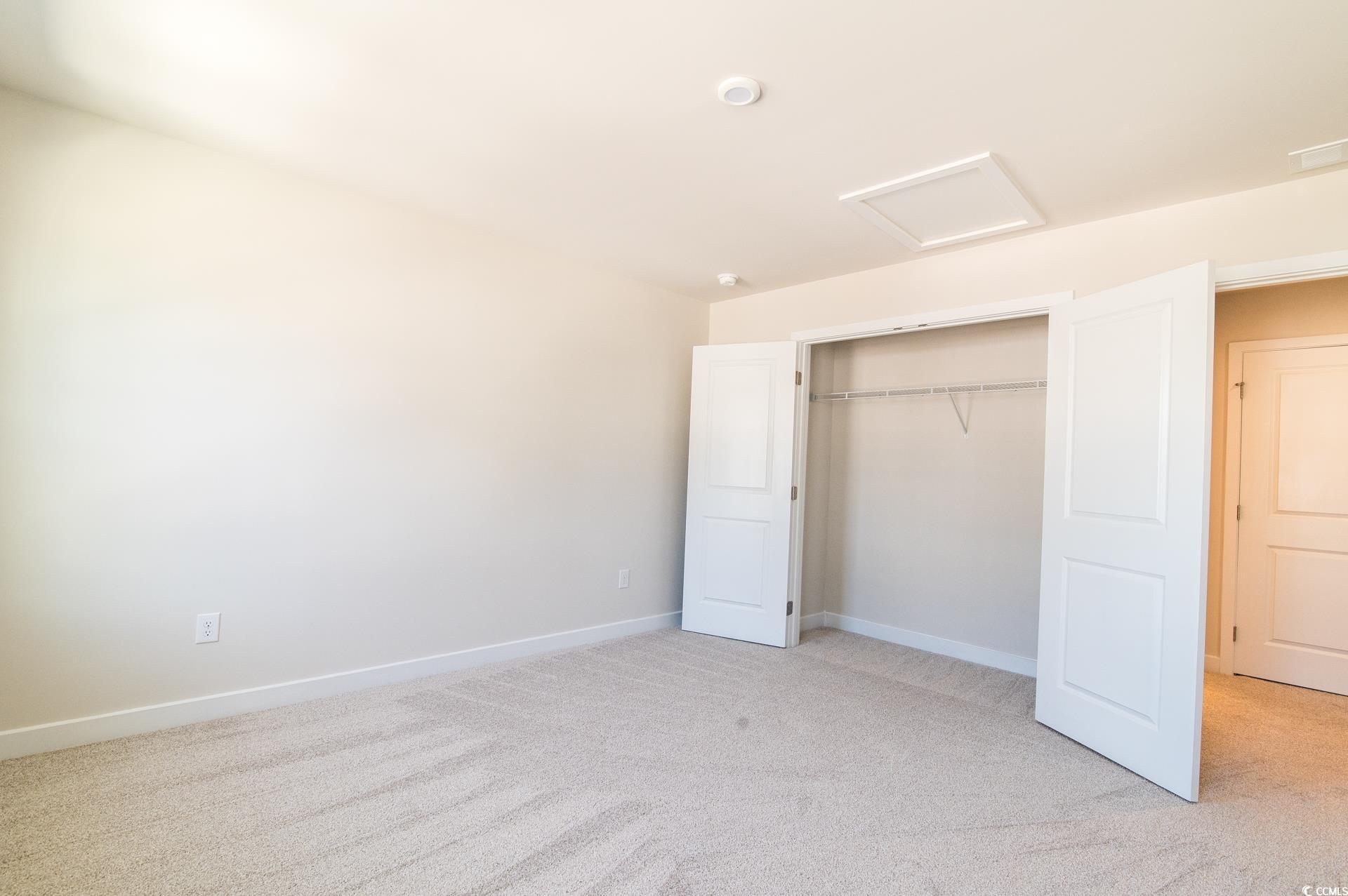 2382 Elowen Lane Longs, SC 29568 - Photo 20 of 36 Unfurnished bedroom with attic access, light colored carpet, and a closet