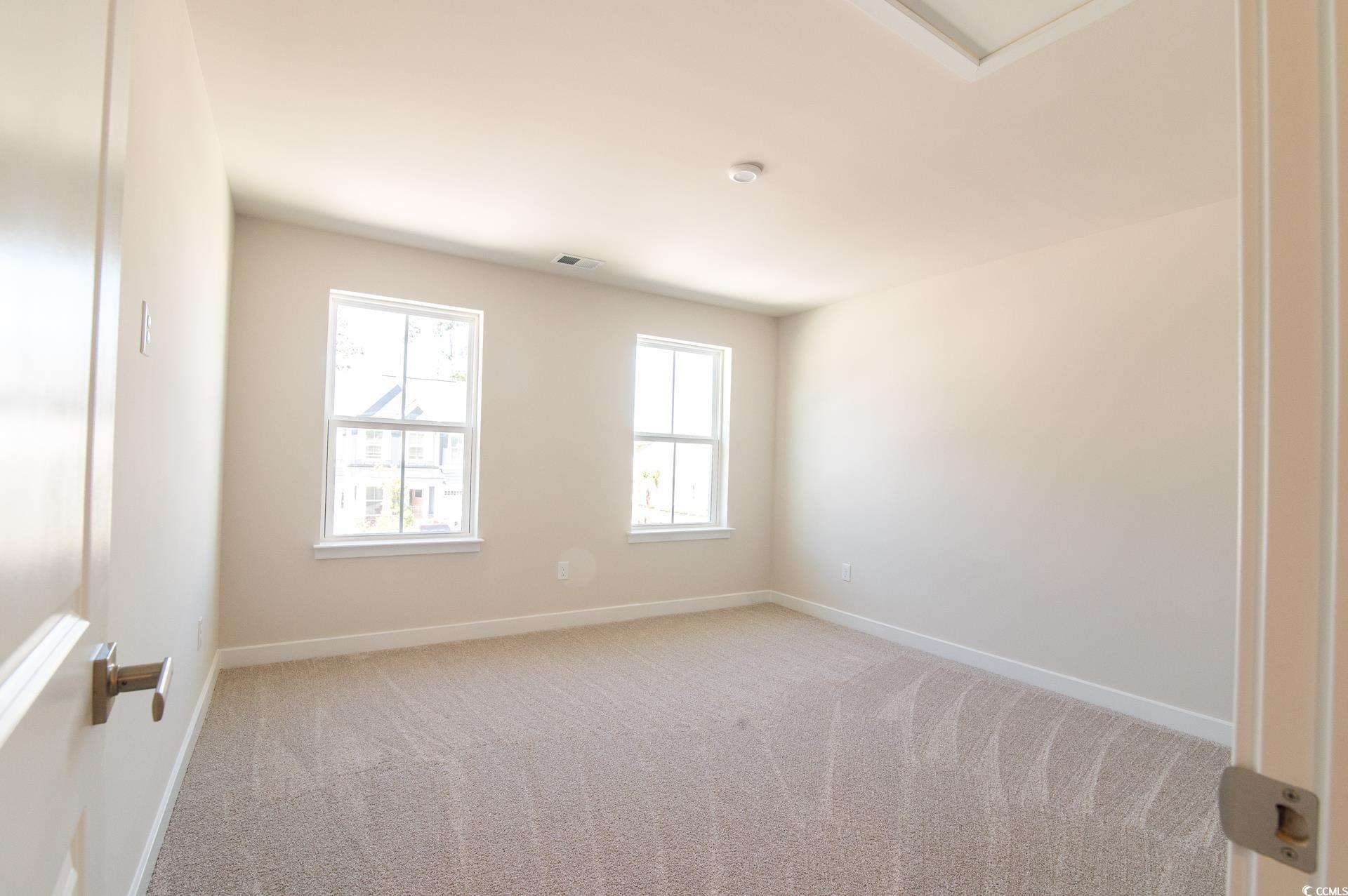 2382 Elowen Lane Longs, SC 29568 - Photo 21 of 36 Empty room featuring light carpet and baseboards