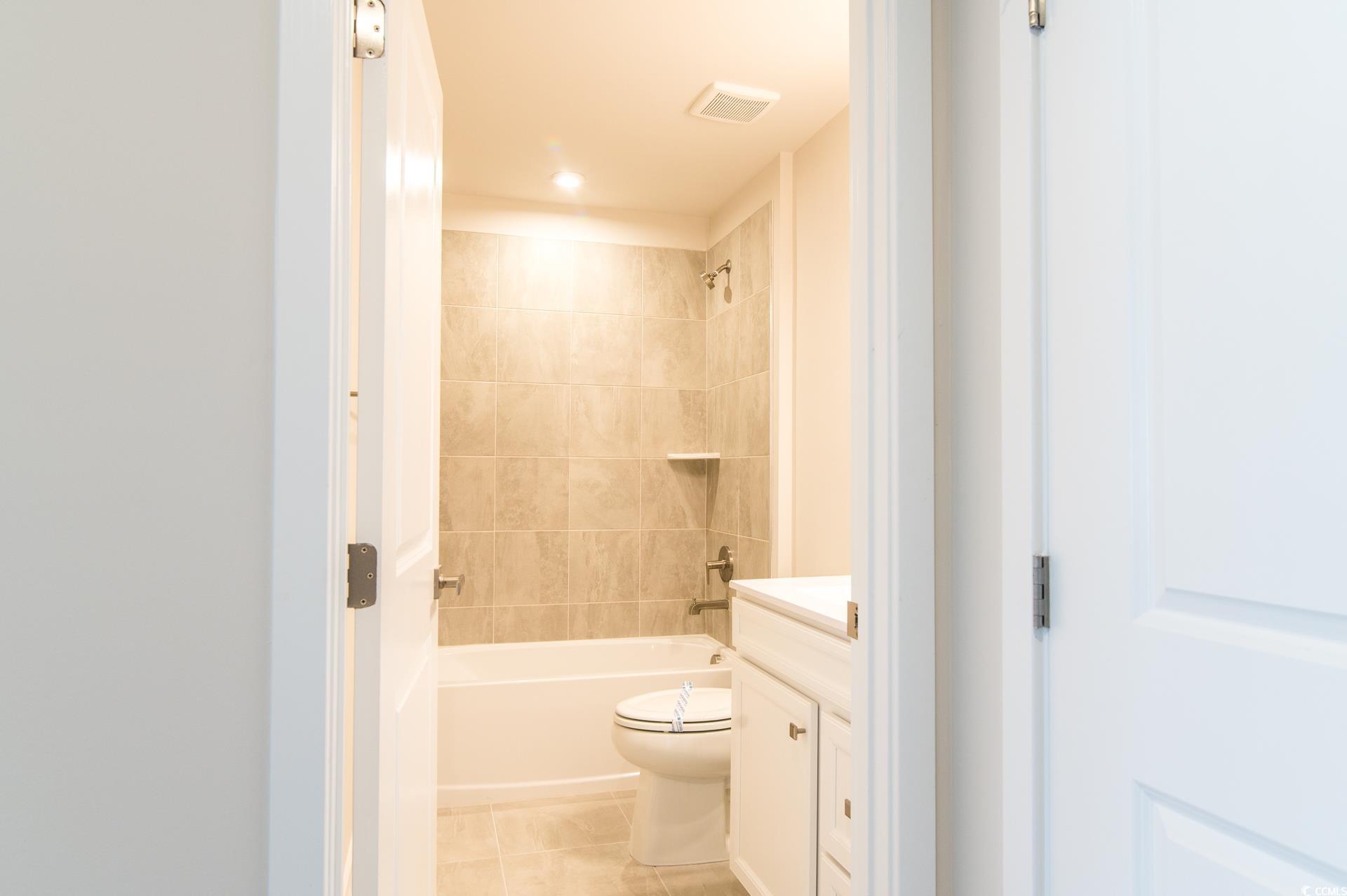 2382 Elowen Lane Longs, SC 29568 - Photo 22 of 36 Full bath featuring vanity, bathtub / shower combination, and light tile patterned floors