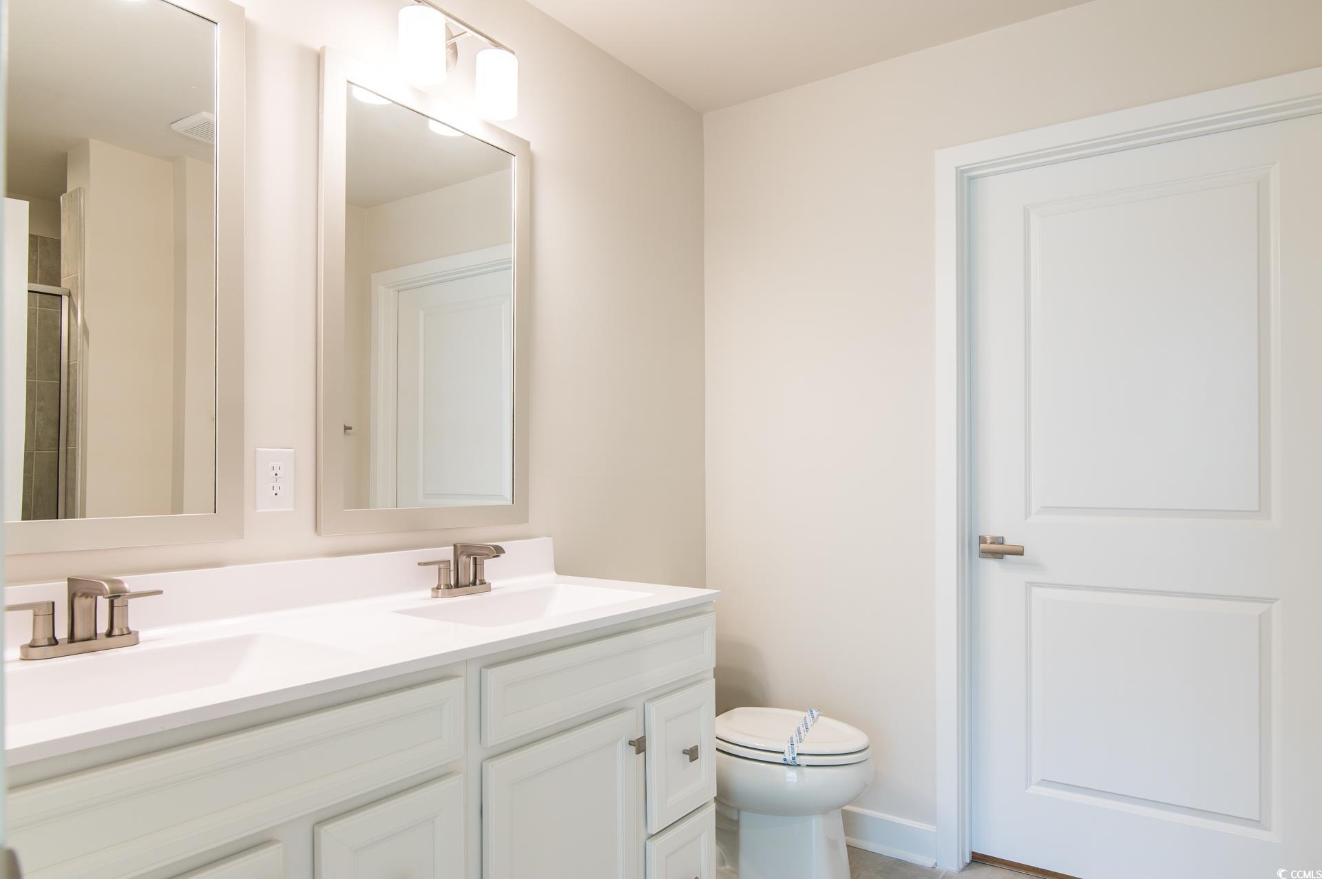 2382 Elowen Lane Longs, SC 29568 - Photo 24 of 36 Full bathroom featuring double vanity and a stall shower