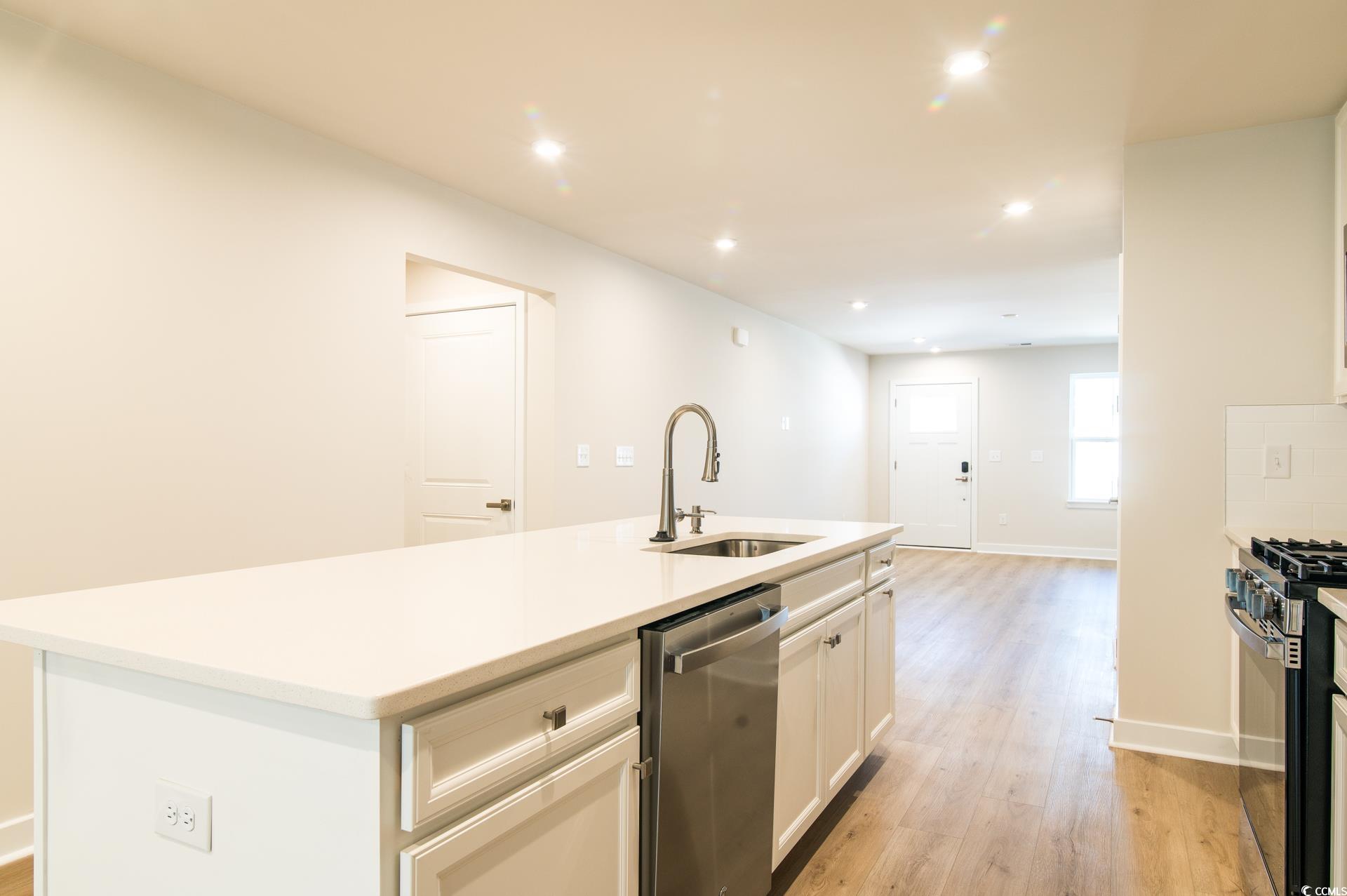 2382 Elowen Lane Longs, SC 29568 - Photo 6 of 36 Kitchen featuring light wood-style floors, stainless steel dishwasher, recessed lighting, an island with sink, and black range with gas cooktop