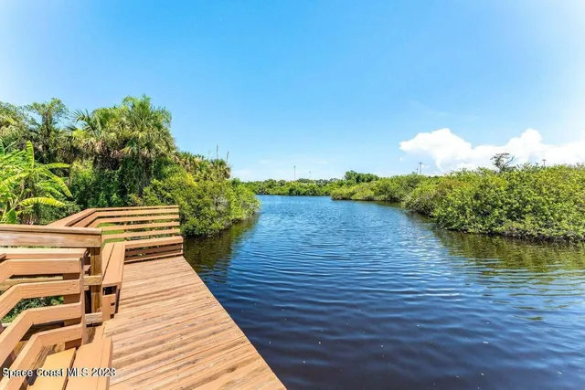 a view of a terrace with wooden floor and lake view