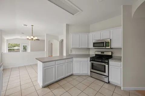 a kitchen with stainless steel appliances a stove sink and cabinets