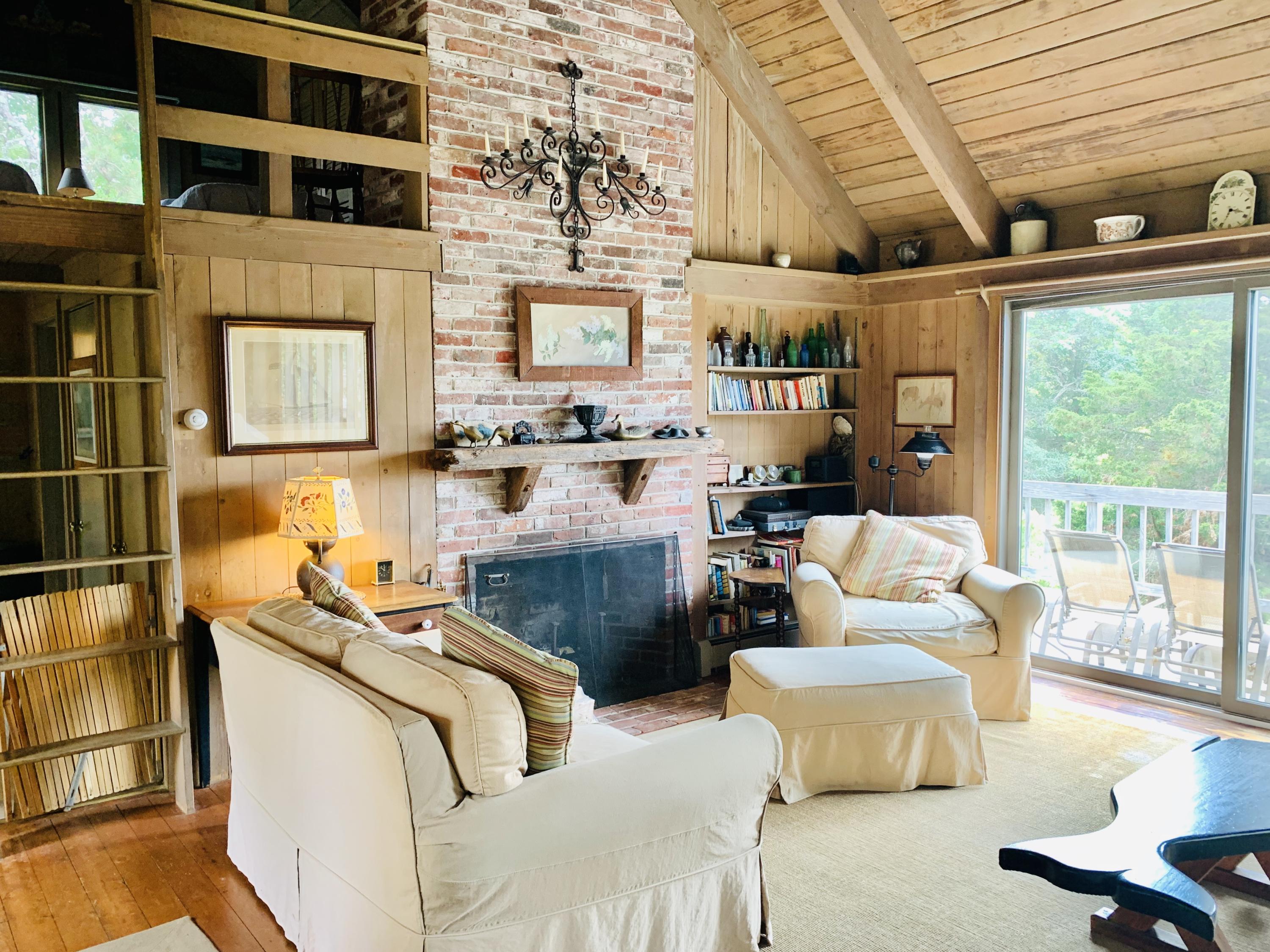24 Alden Road Orleans, MA 02653 - Photo 7 of 27 a living room with furniture and a floor to ceiling window