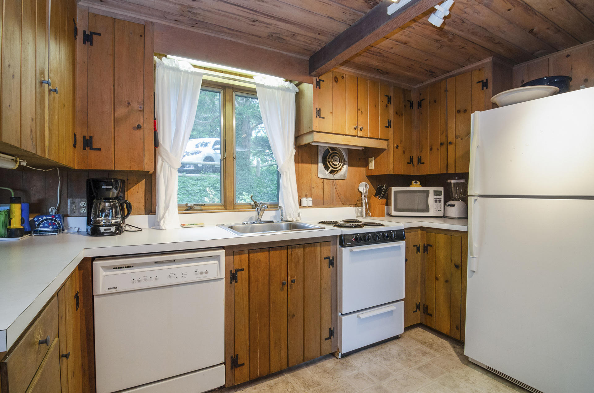 24 Alden Road Orleans, MA 02653 - Photo 9 of 27 a kitchen with stainless steel appliances granite countertop a refrigerator a sink and white cabinets