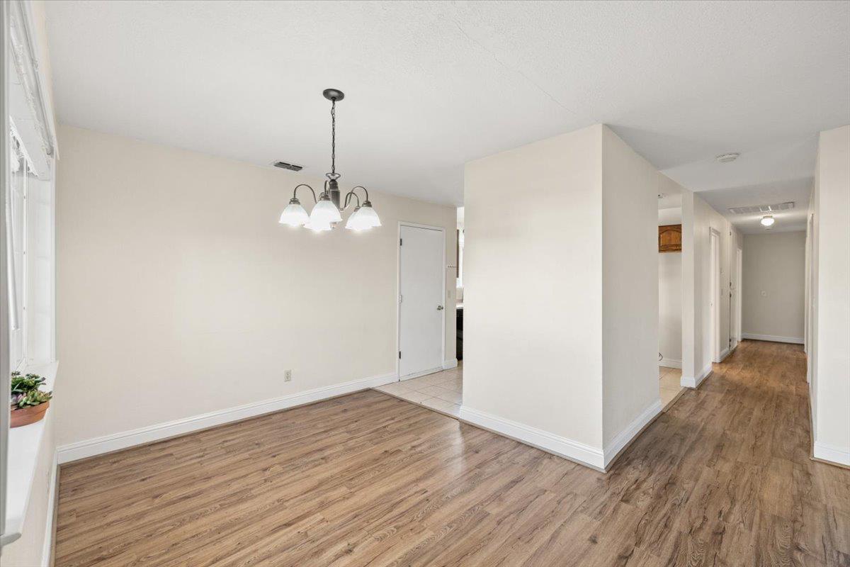 6318 David Avenue Loomis, CA 95650 - Photo 12 of 26 a view of a chandelier in an empty room with wooden floor and a chandelier