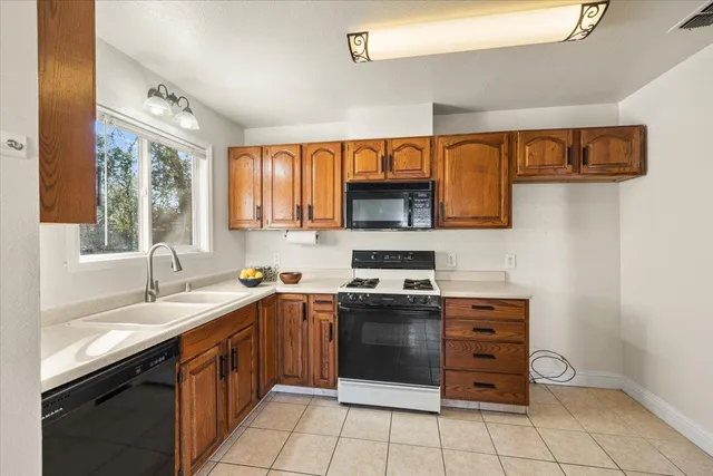 a kitchen with stainless steel appliances granite countertop a sink and cabinets