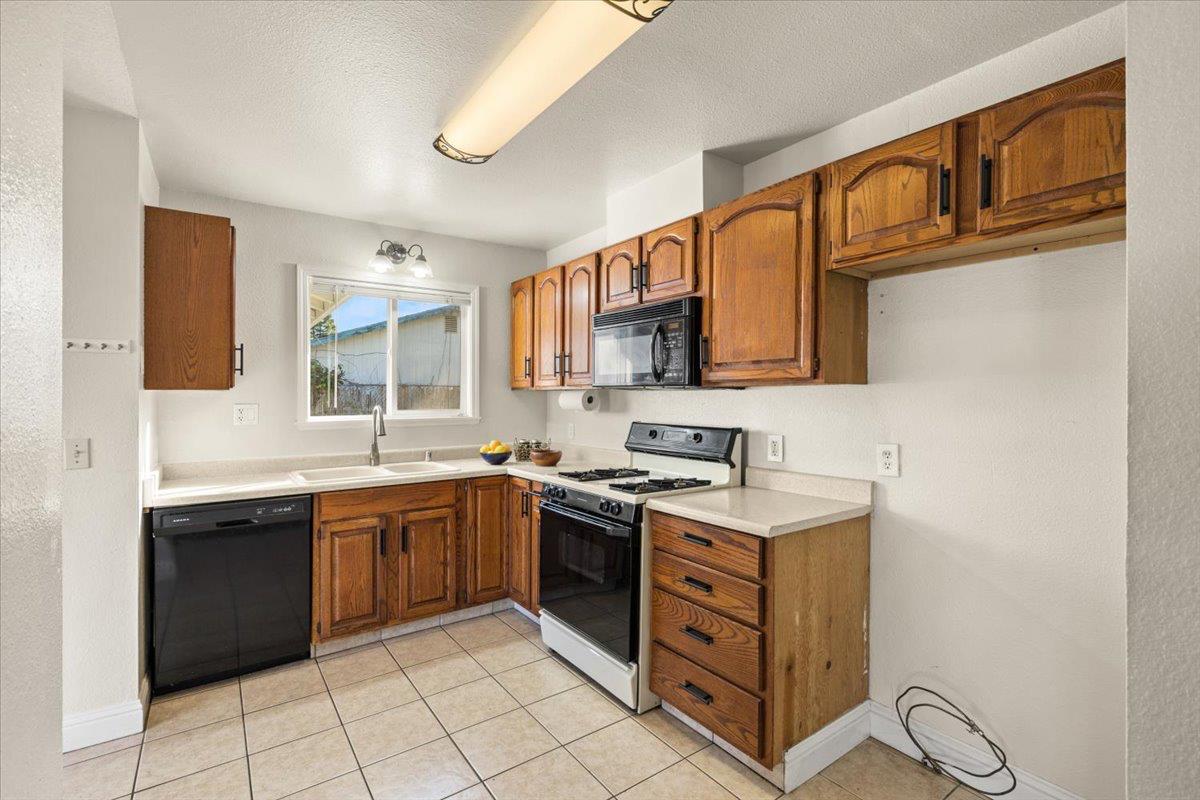 6318 David Avenue Loomis, CA 95650 - Photo 15 of 26 a kitchen with stainless steel appliances granite countertop a sink and cabinets