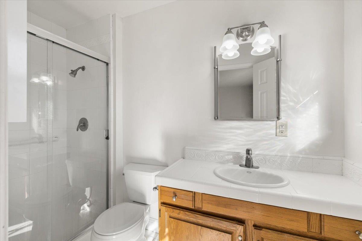 6318 David Avenue Loomis, CA 95650 - Photo 19 of 26 a bathroom with a sink a toilet and shower