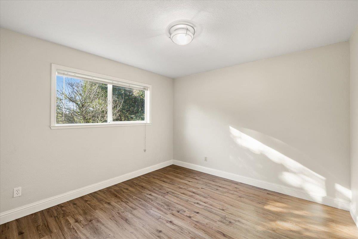 6318 David Avenue Loomis, CA 95650 - Photo 20 of 26 an empty room with wooden floor and windows