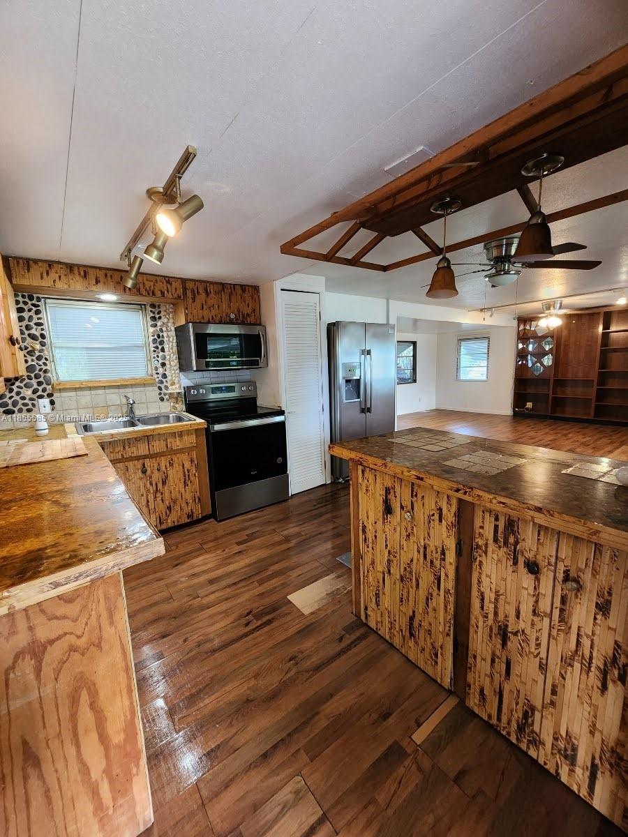1590 Southwest 65th Terrace, Unit H Boca Raton, FL 33428 - Photo 4 of 17 a view of kitchen with cabinets and wooden floor