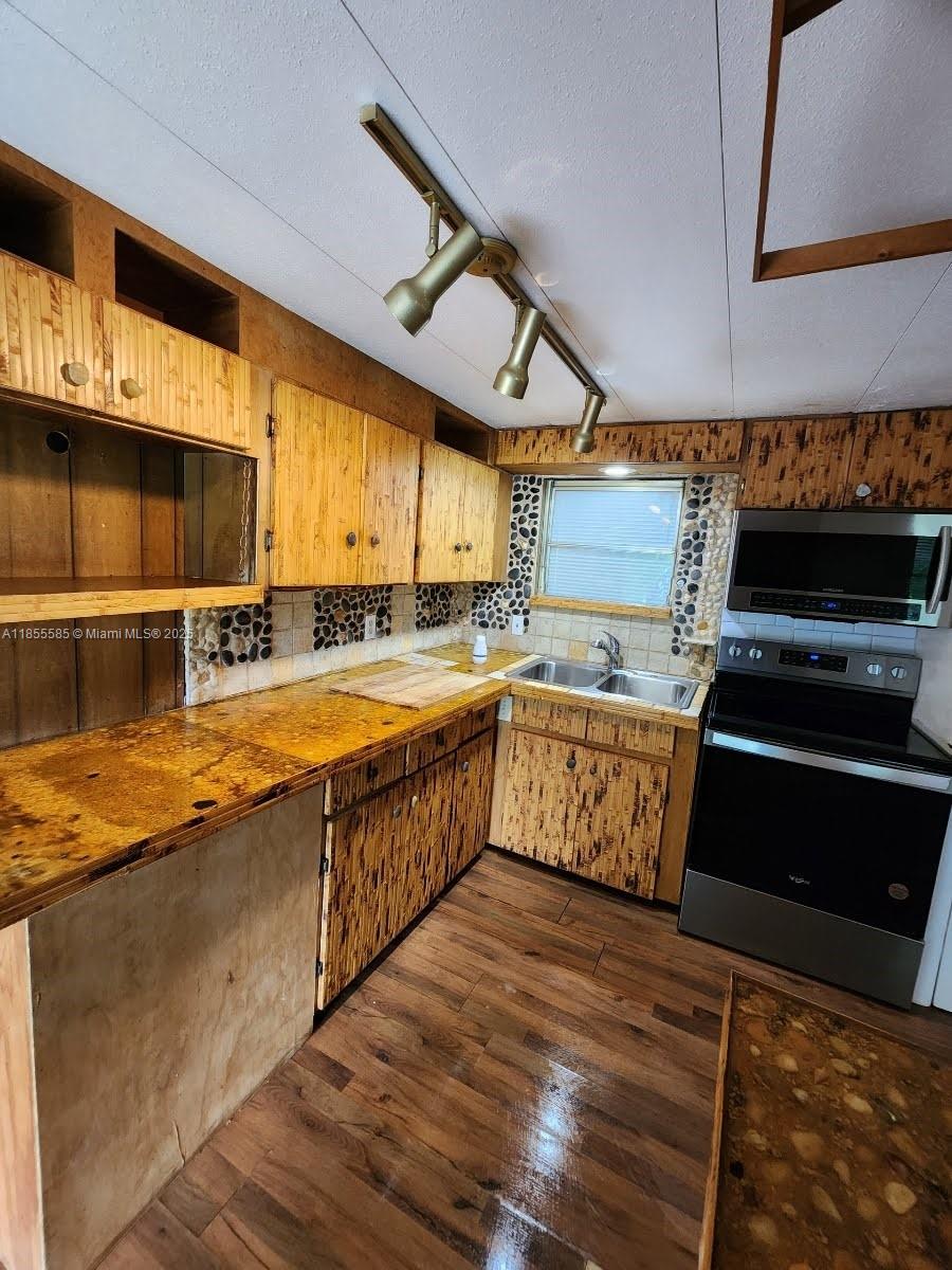 1590 Southwest 65th Terrace, Unit H Boca Raton, FL 33428 - Photo 5 of 17 a kitchen with stainless steel appliances granite countertop a large counter top a stove and a sink