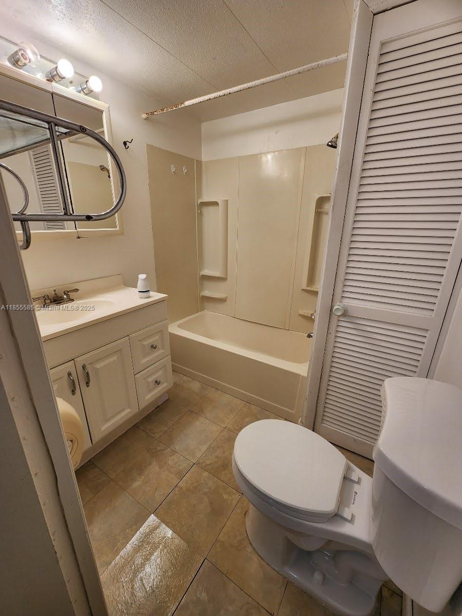1590 Southwest 65th Terrace, Unit H Boca Raton, FL 33428 - Photo 10 of 17 a bathroom with a sink a toilet a mirror and shower