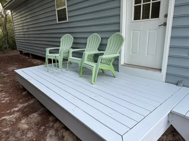 a wooden bench sitting in front of a house