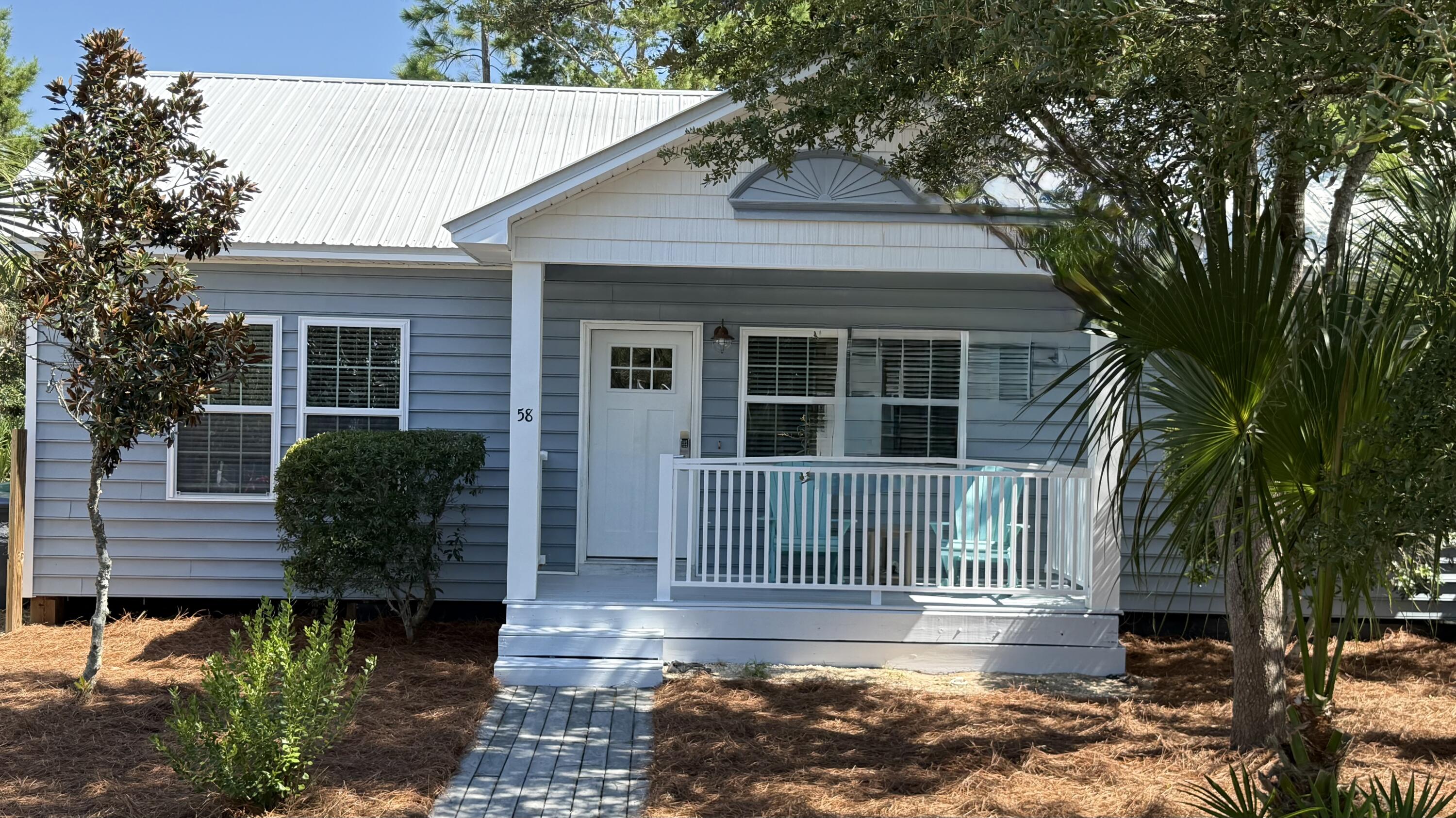 58 Gulf Cove Court Santa Rosa Beach, FL 32459 - Photo 2 of 29 a view of a house with a small yard plants and large tree
