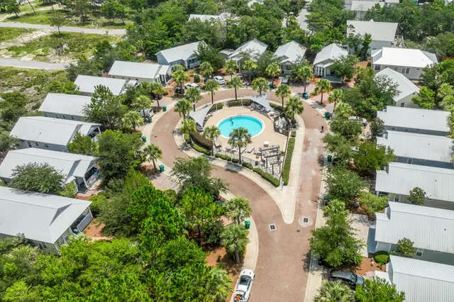 an aerial view of residential house with outdoor space and trees all around