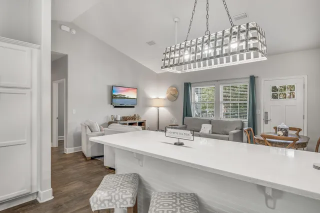a dining room with a chandelier and a couch
