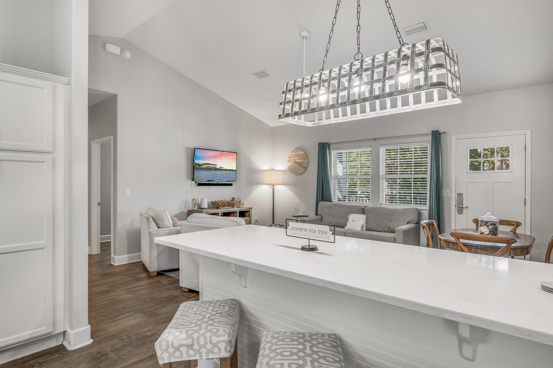 58 Gulf Cove Court Santa Rosa Beach, FL 32459 - Photo 5 of 29 a dining room with a chandelier and a couch