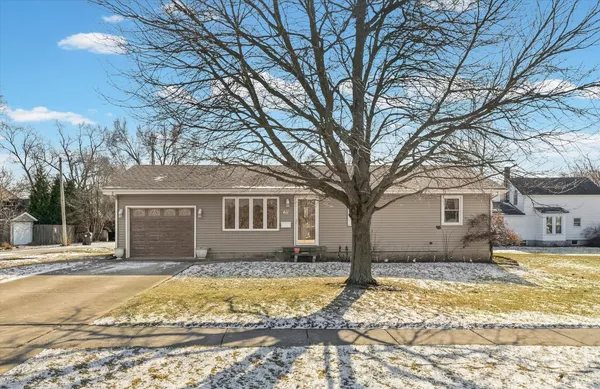 a house that has a tree in front of it
