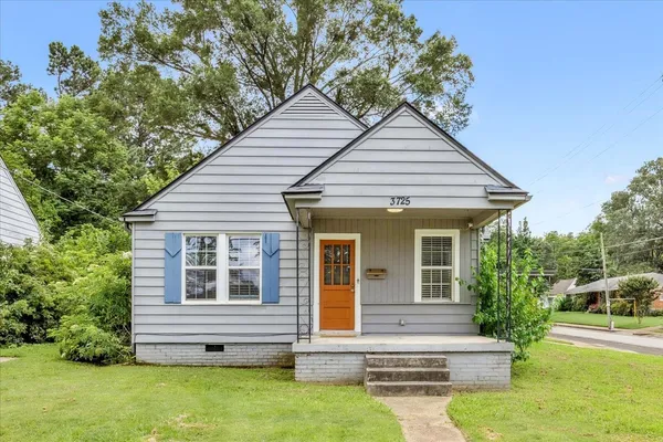 a view of house with backyard and garden