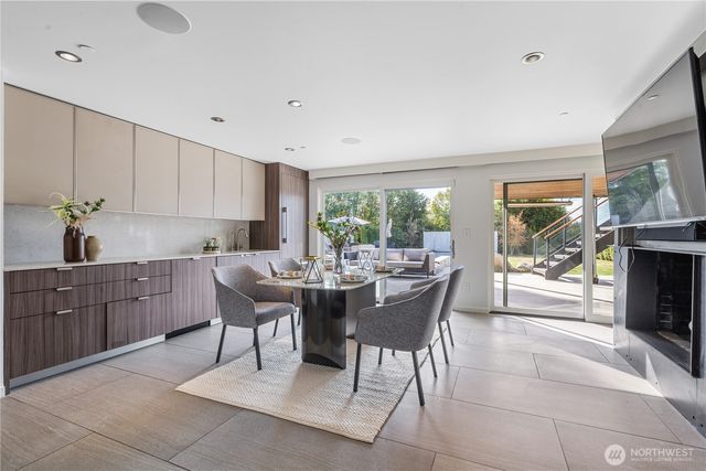 a living room with furniture a fireplace and a large window