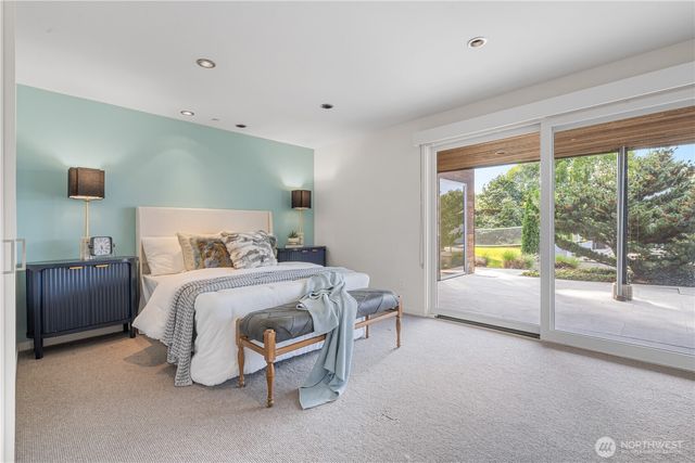 a bedroom with a bed and a night stand