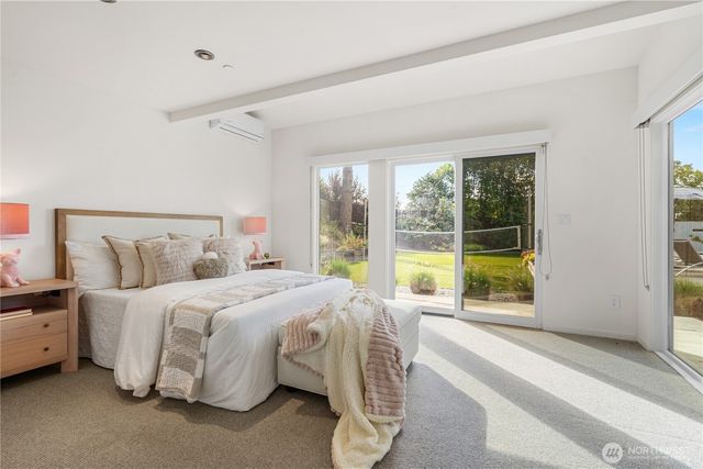 a spacious bedroom with a bed and a large window