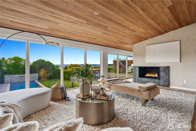 a living room with patio furniture and a fireplace