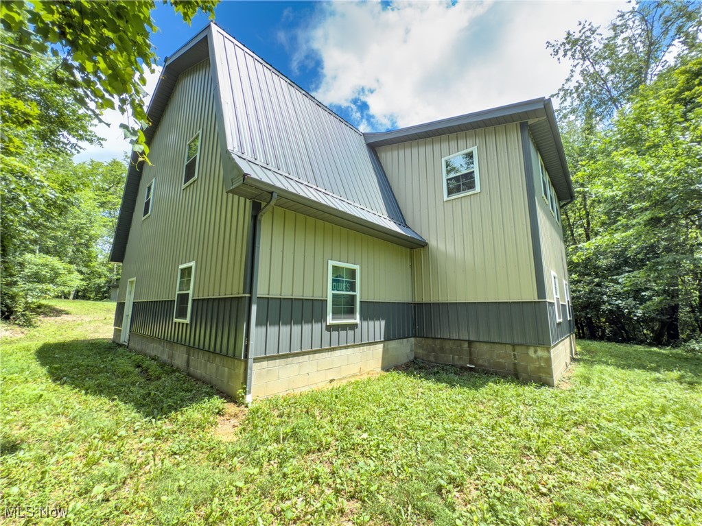 59900 Ramsey Ridge Road Jacobsburg, OH 43933 - Photo 11 of 35 View of home's exterior with a lawn and a metal roof