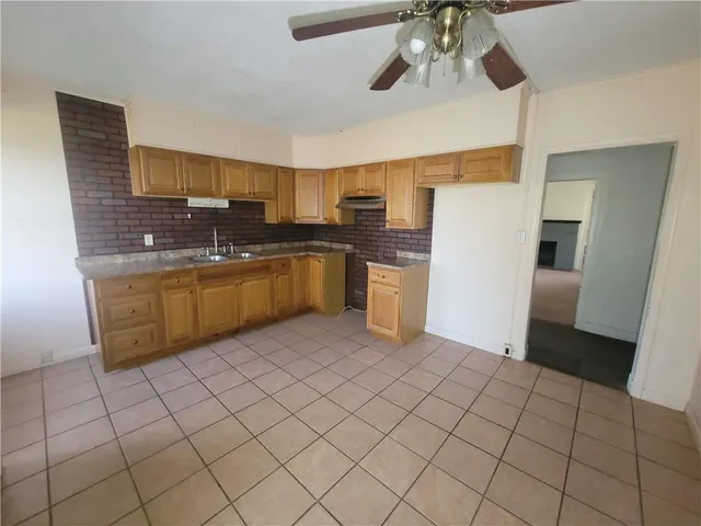 a kitchen with stainless steel appliances granite countertop a sink and cabinets