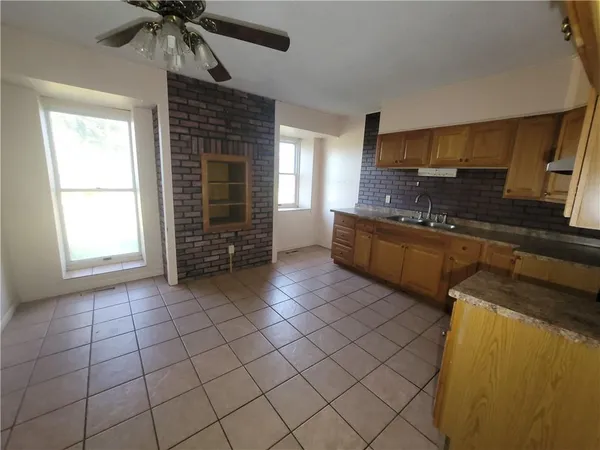 a kitchen with stainless steel appliances a sink cabinets and a window