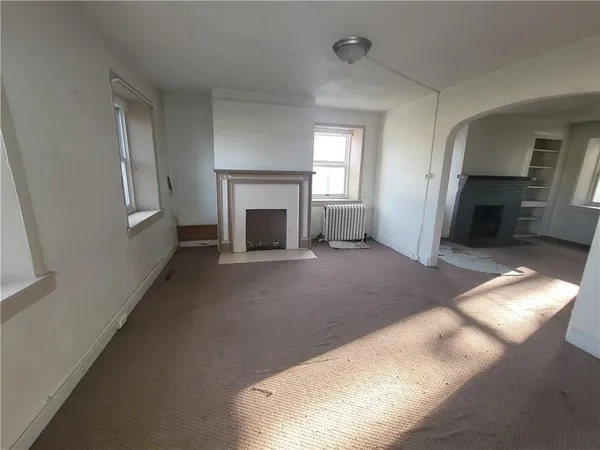 a view of empty room with fireplace