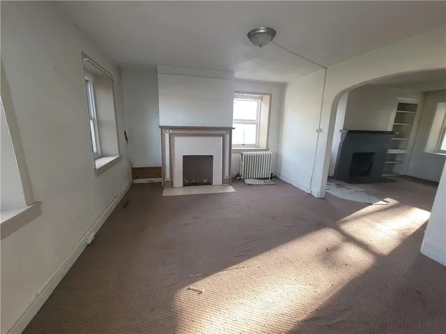 a view of empty room with fireplace