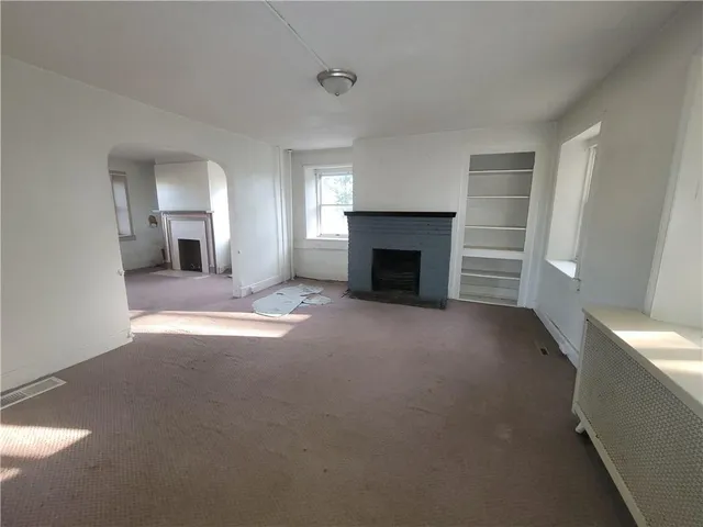 a view of empty room with a fireplace