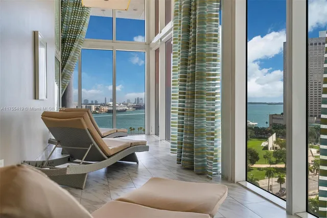 a balcony with couple of chairs and a window