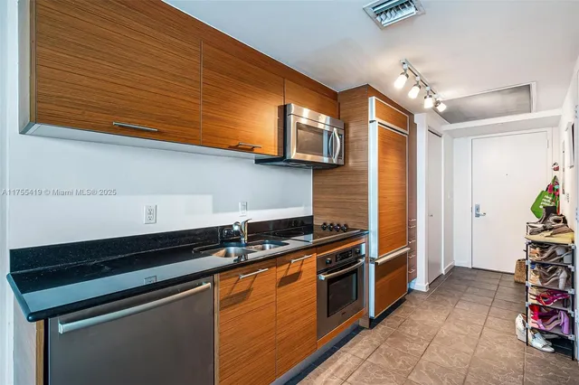 a kitchen that has a sink and a stove