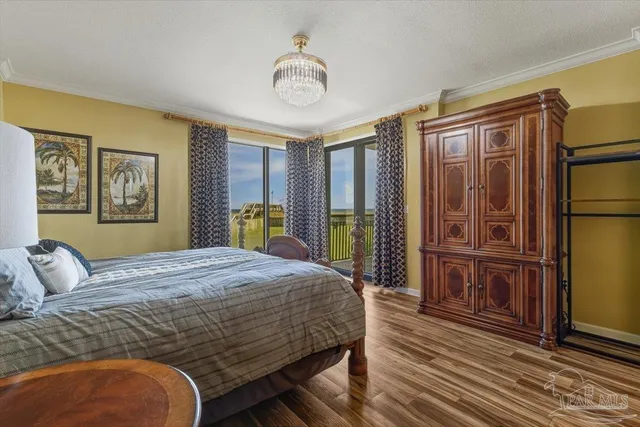 a bedroom with a large bed and dresser