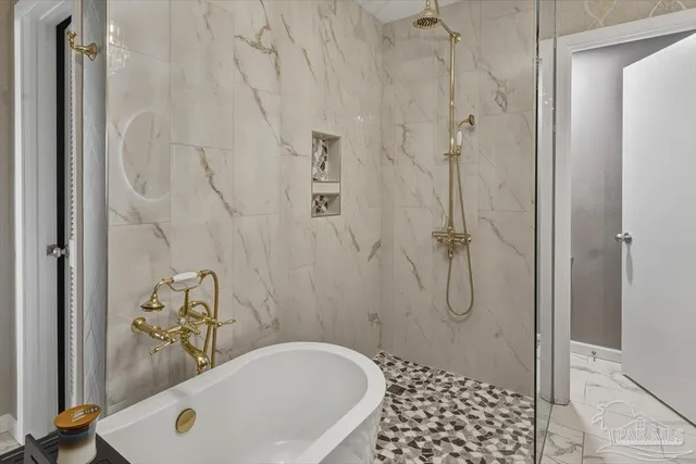 a bathroom with a bathtub and shower