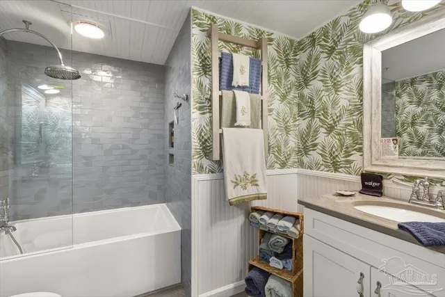 a bathroom with a tub sink and mirror