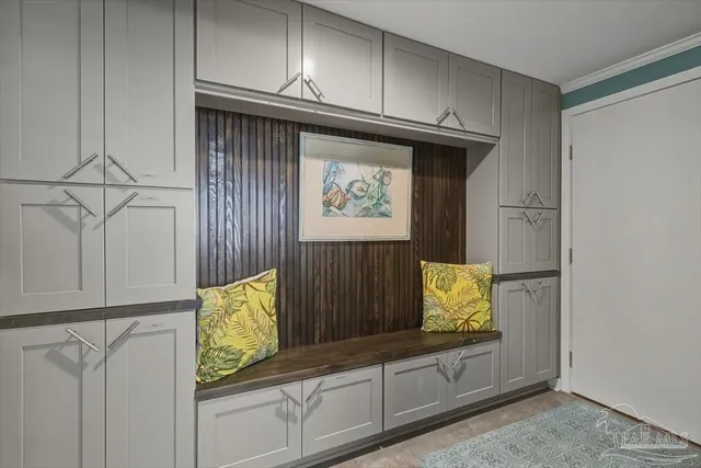 a view of front door with cabinets