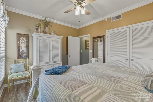 a bedroom with a large bed a chandelier and closet